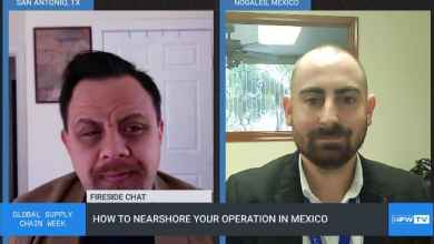 A screen shot of two men talking to each other.