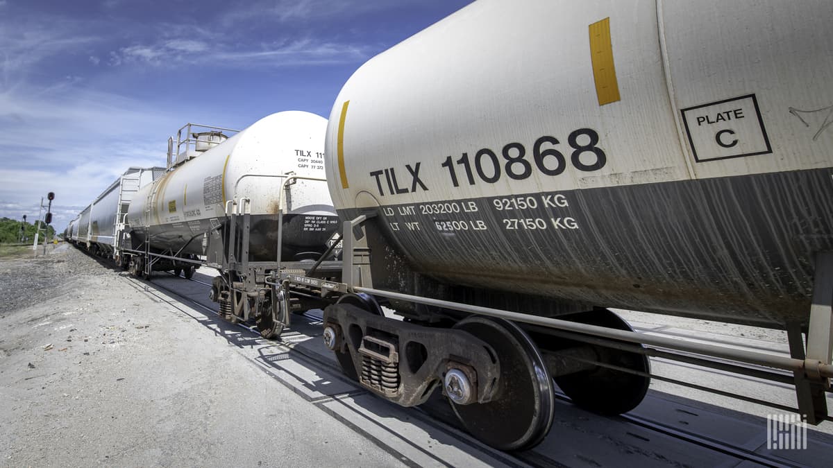 A photograph of tank cars parked in a rail yard.