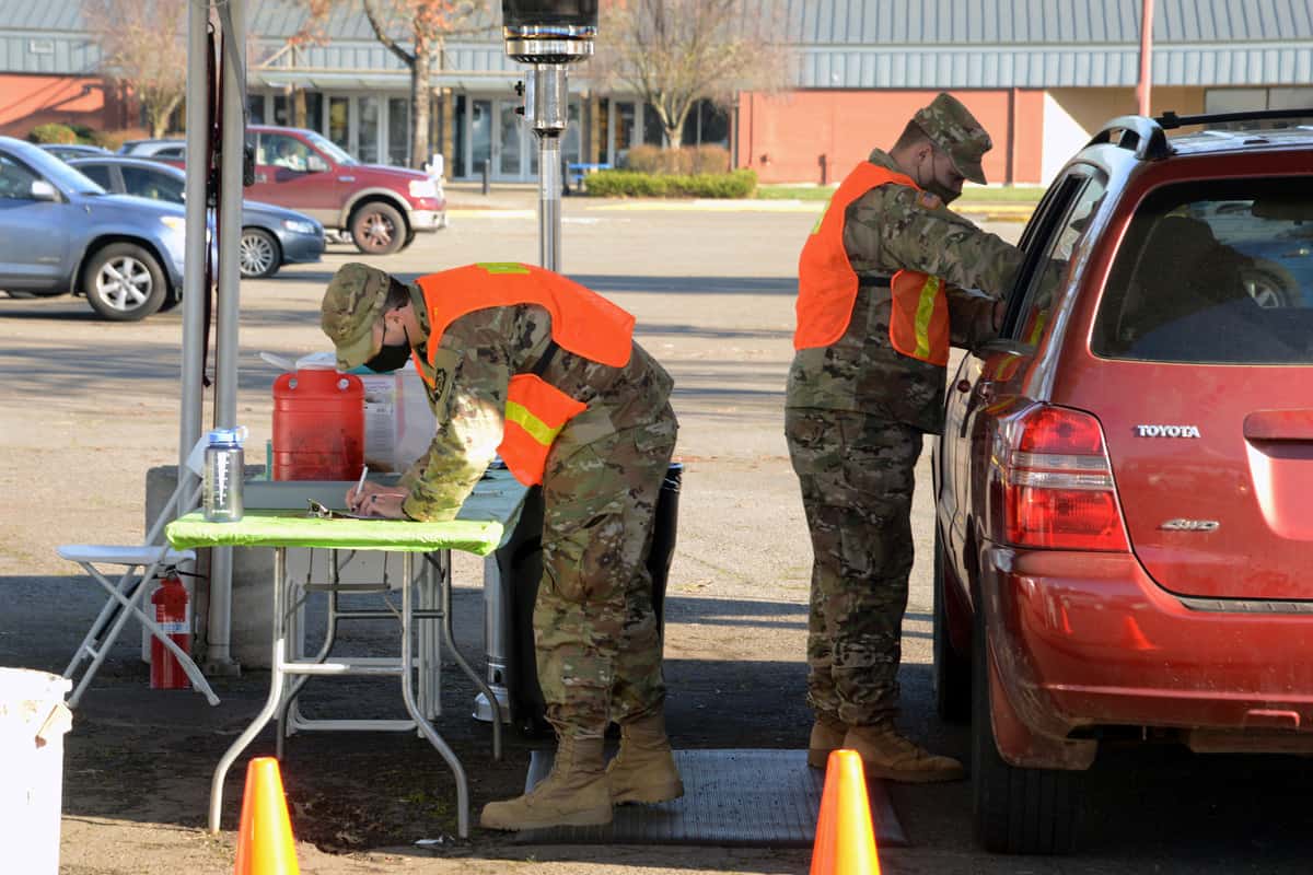 Members of the Oregon Army National Guard prepare to administer COVID-19 vaccines during a mass vaccination clinic in Eugene, Oregon.
