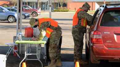 Members of the Oregon Army National Guard prepare to administer COVID-19 vaccines during a mass vaccination clinic in Eugene, Oregon.