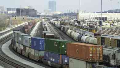 A photograph of intermodal containers parked at a rail yard.