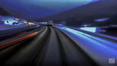 Tractor-trailer heading down icy/snowy highway.