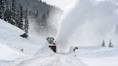 A photograph of a snow plow clearing a road.