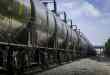 A photograph of tank cars parked in a rail yard.