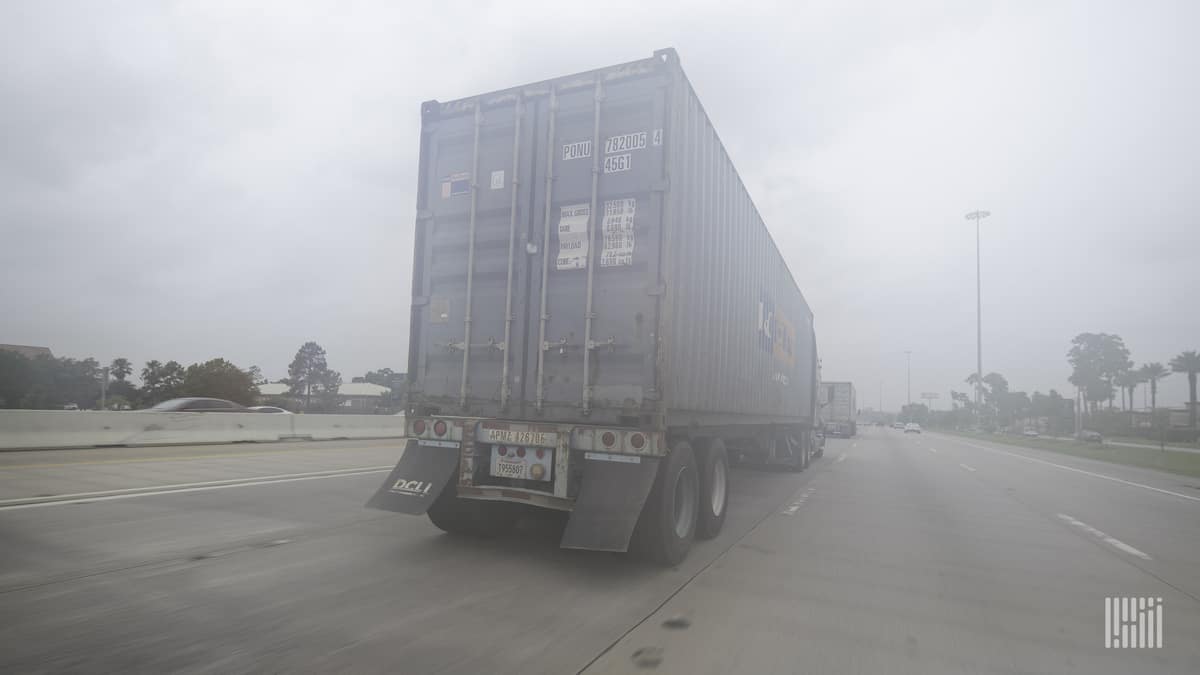 Tractor-trailer parked on a foggy day.