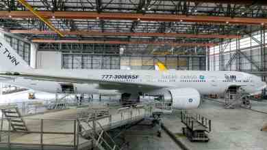 A large white plane in a hangar.