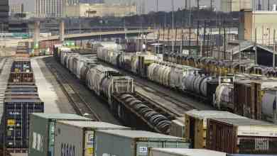 A photograph of railcars parked in a rail yard.