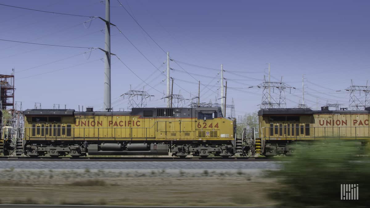 A photograph of two Union Pacific locomotives parked in a rail yard.