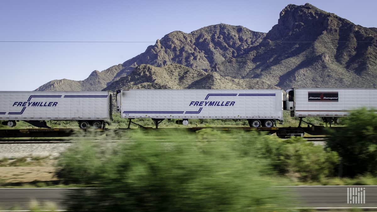 A photograph of a train carrying intermodal trailers.
