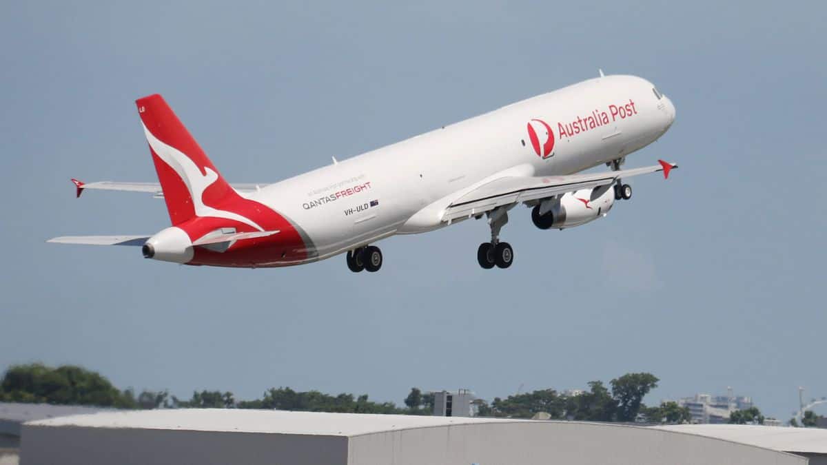 A white jet with red tail takes off.