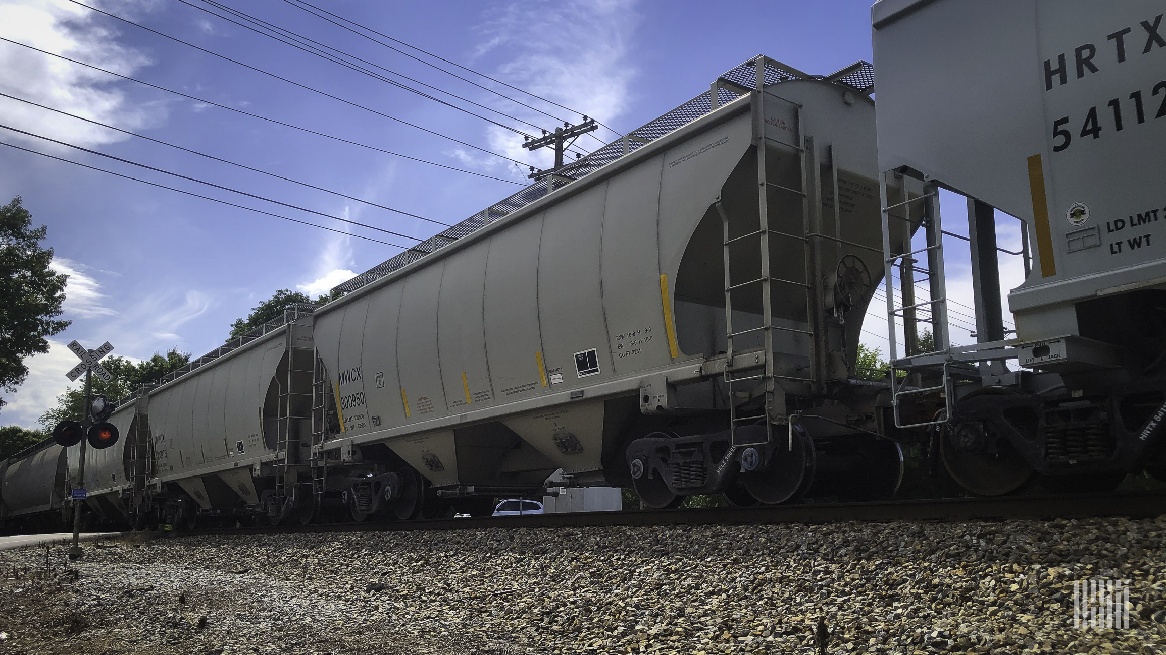 A photograph of hopper cars on a train.