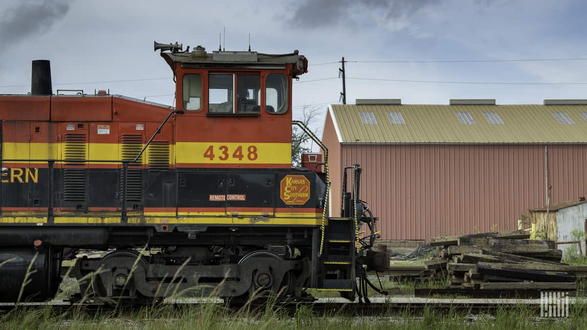A photograph of a Kansas City Southern train in a rail yard.