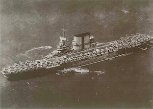 Crowley tugs escort an early aircraft carrier. (Photo Crowley)