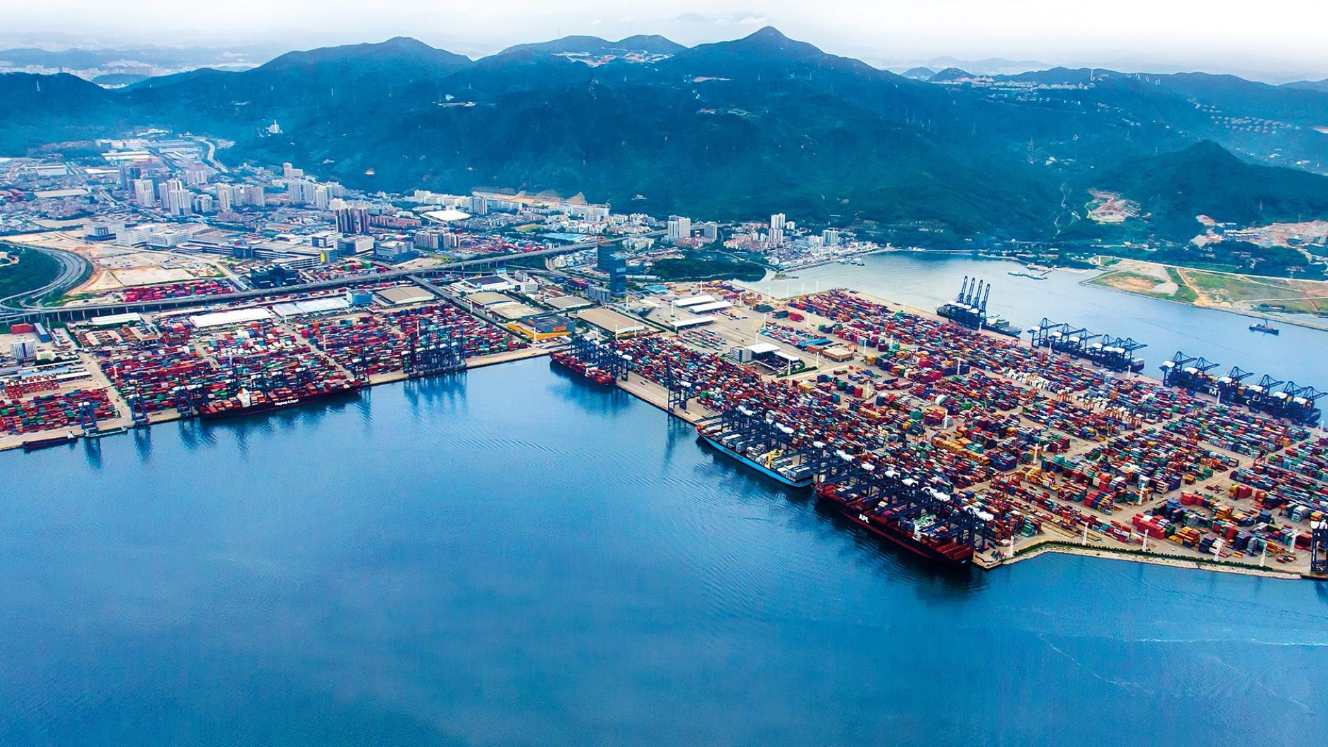 Aerial view of the Port of Yantian in Shenzhen, China, with lots of containers stacked on the wharf.