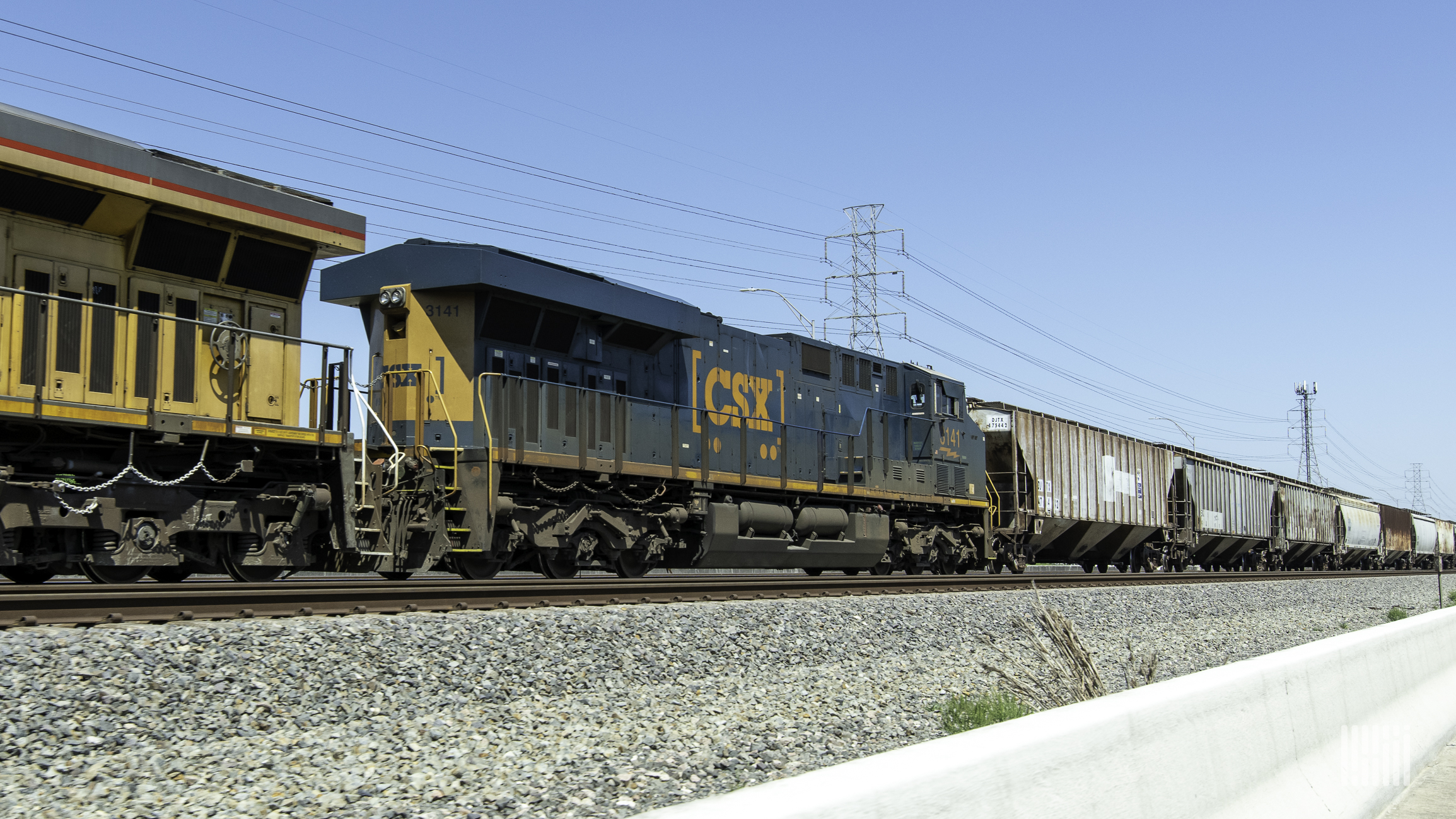 A photograph of a CSX train at a rail yard.