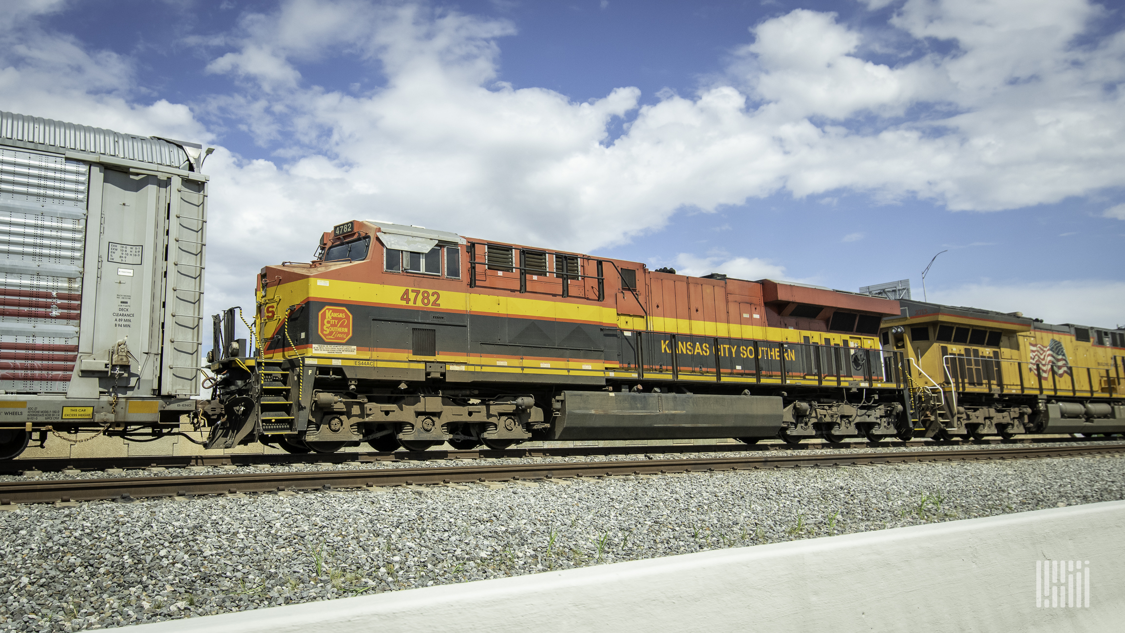 A photograph of a KCS train at a rail yard.
