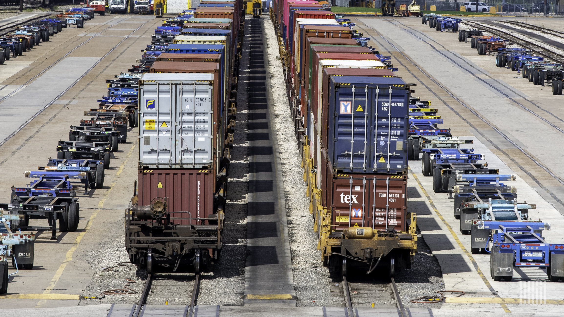 A photograph of containers parked in a rail yard.