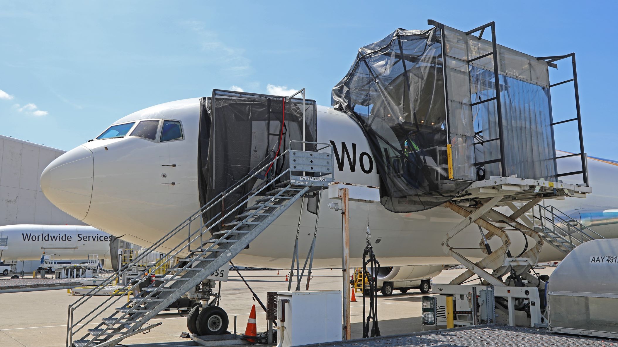 A UPS cargo plane with giant netting system over the open cargo door to catch bugs.