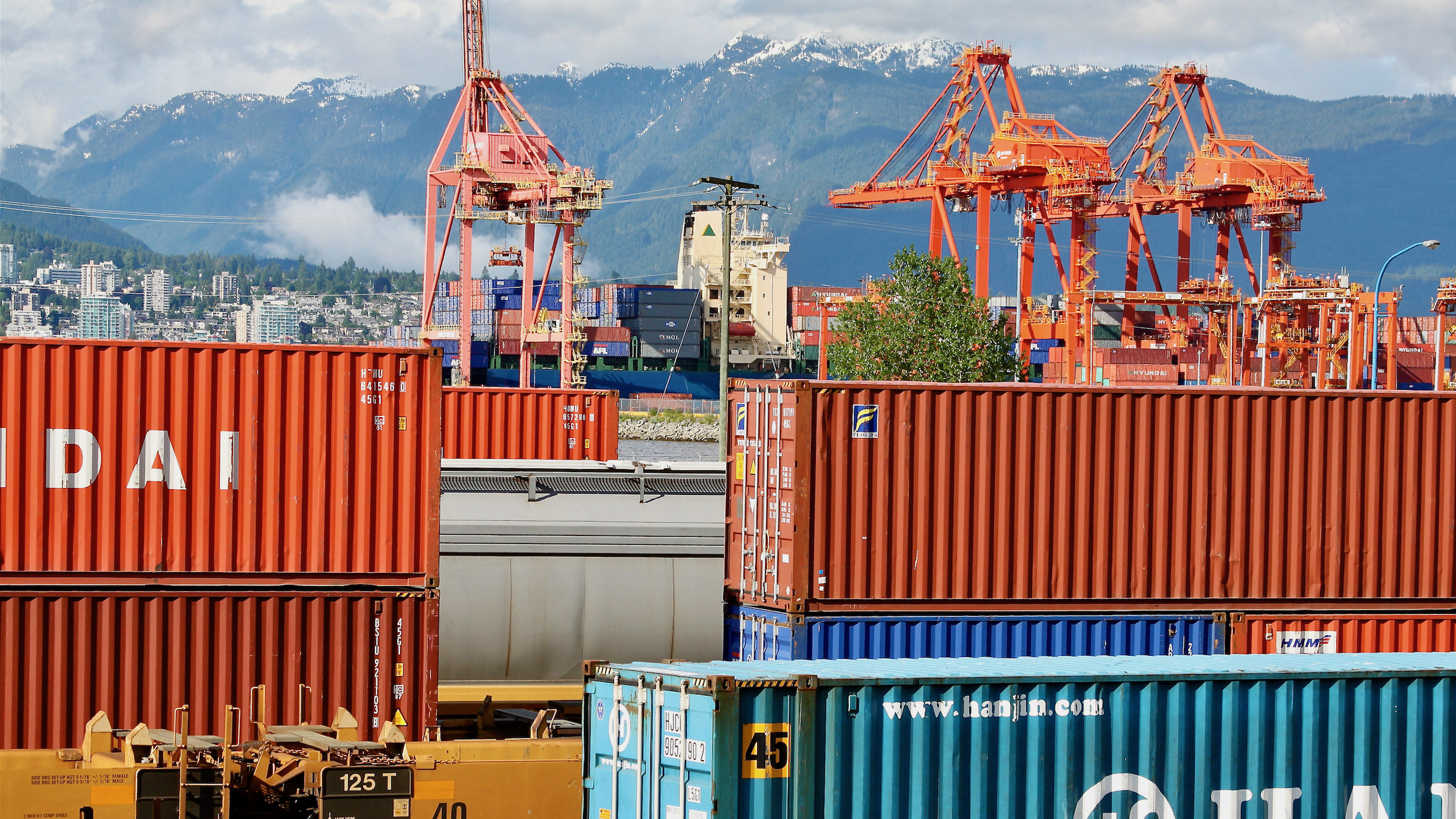 Intermodal containers on trains outside the Port of Vancouver - in the background.