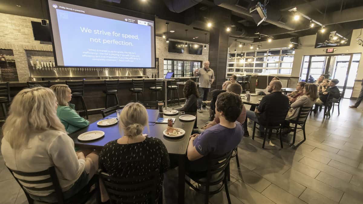 In a pre-COVID photograph, Craig Fuller presents to new FreightWaves employees in the company's Freight Alley. 
(Photo: FreightWaves staff)