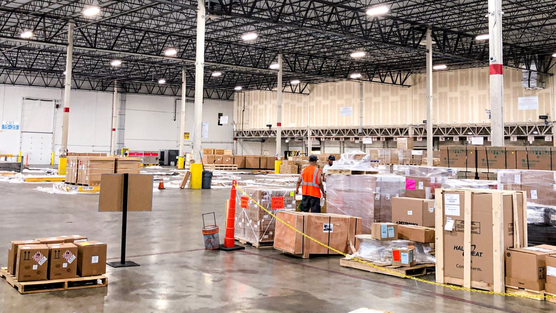 Boxes and loose cargo spread around warehouse floor.