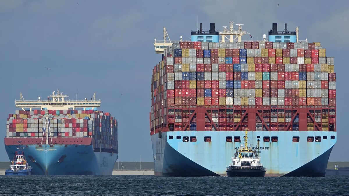 Two Maersk ships with containers stacked on them.
