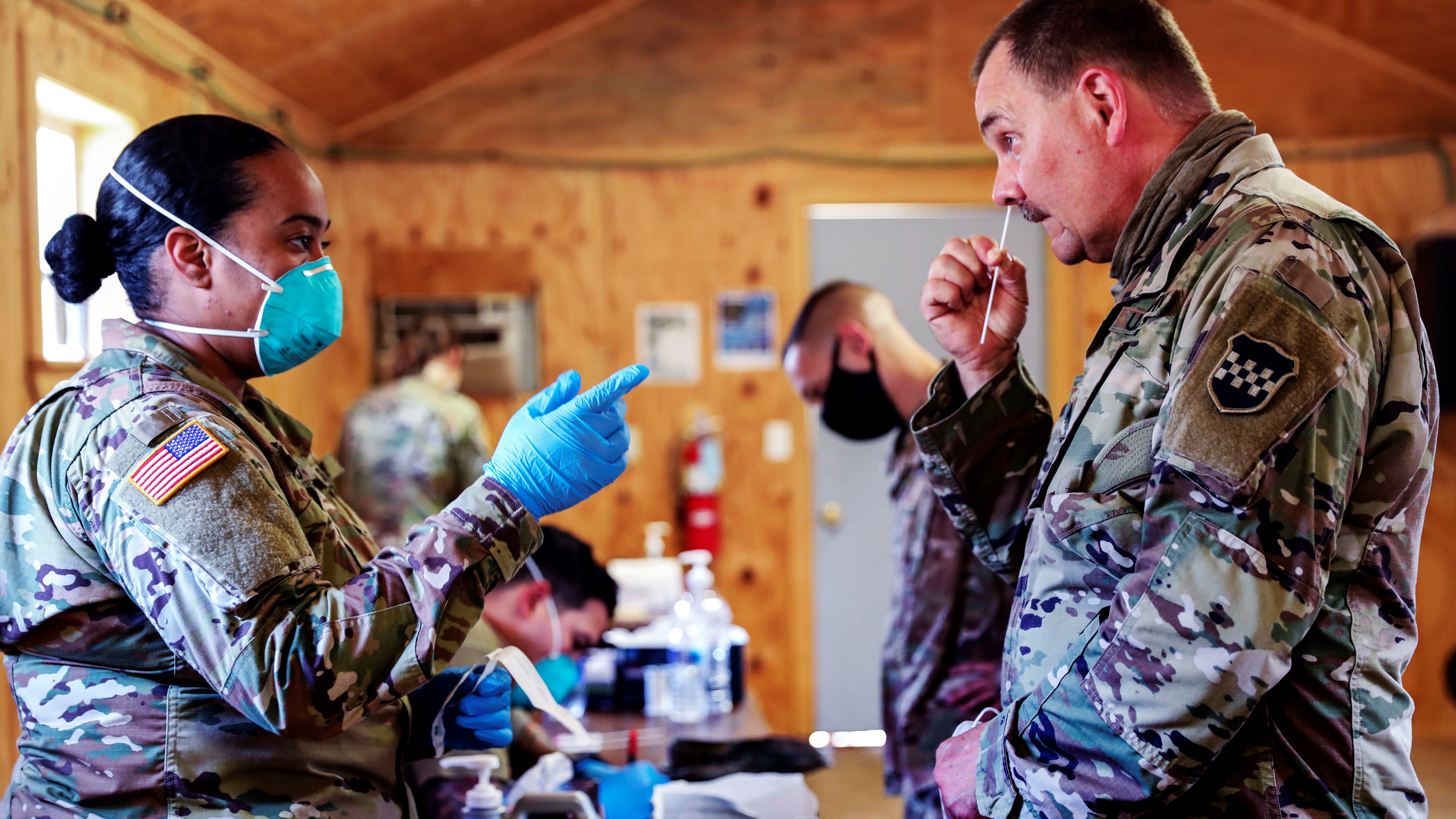 An Army sergeant instructs a service member on how to use a nasal swab for a COVID-19 screening test at Fort McCoy, Wisconsin, in August. (Photo: Department of Defense/Nicholas Nystedt)