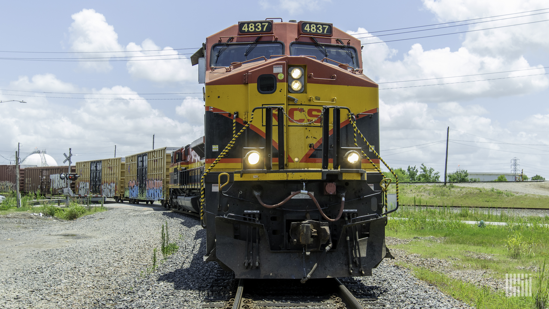 A photograph of a Kansas City Southern train hauling intermodal containers.
