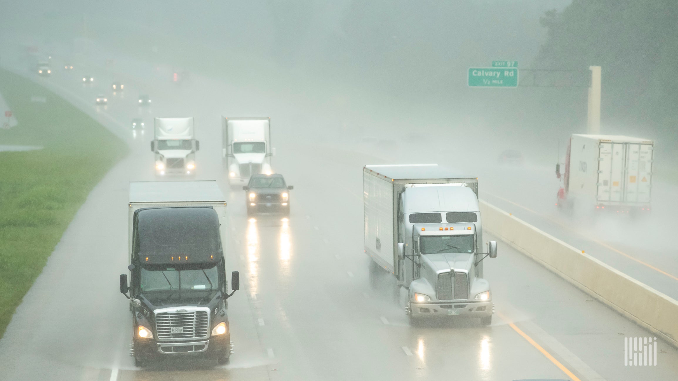 Tractor-trailers in heavy rain.