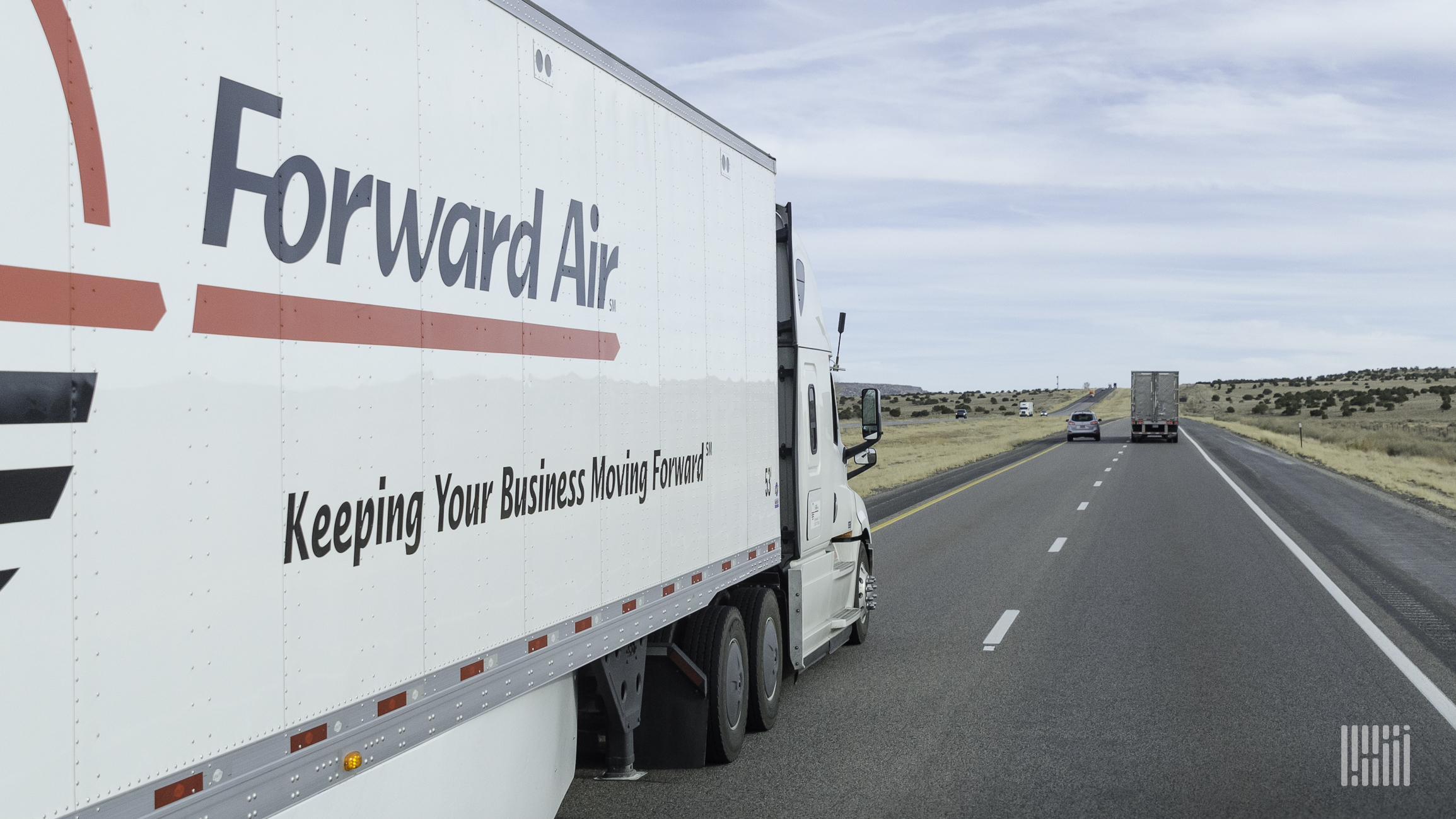 A tractor-trailer with the logo Forward Air seen from the right year side on a highway to illustrate an article about a ransomware attack on the company.