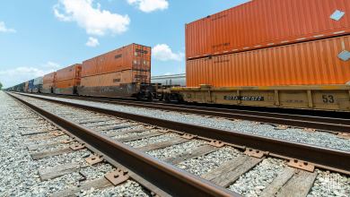 A photograph of intermodal containers on a rail track.