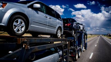 A truck transporting cars to viewed from the front right to illustrate an article about an acquisition by the company Trade X.