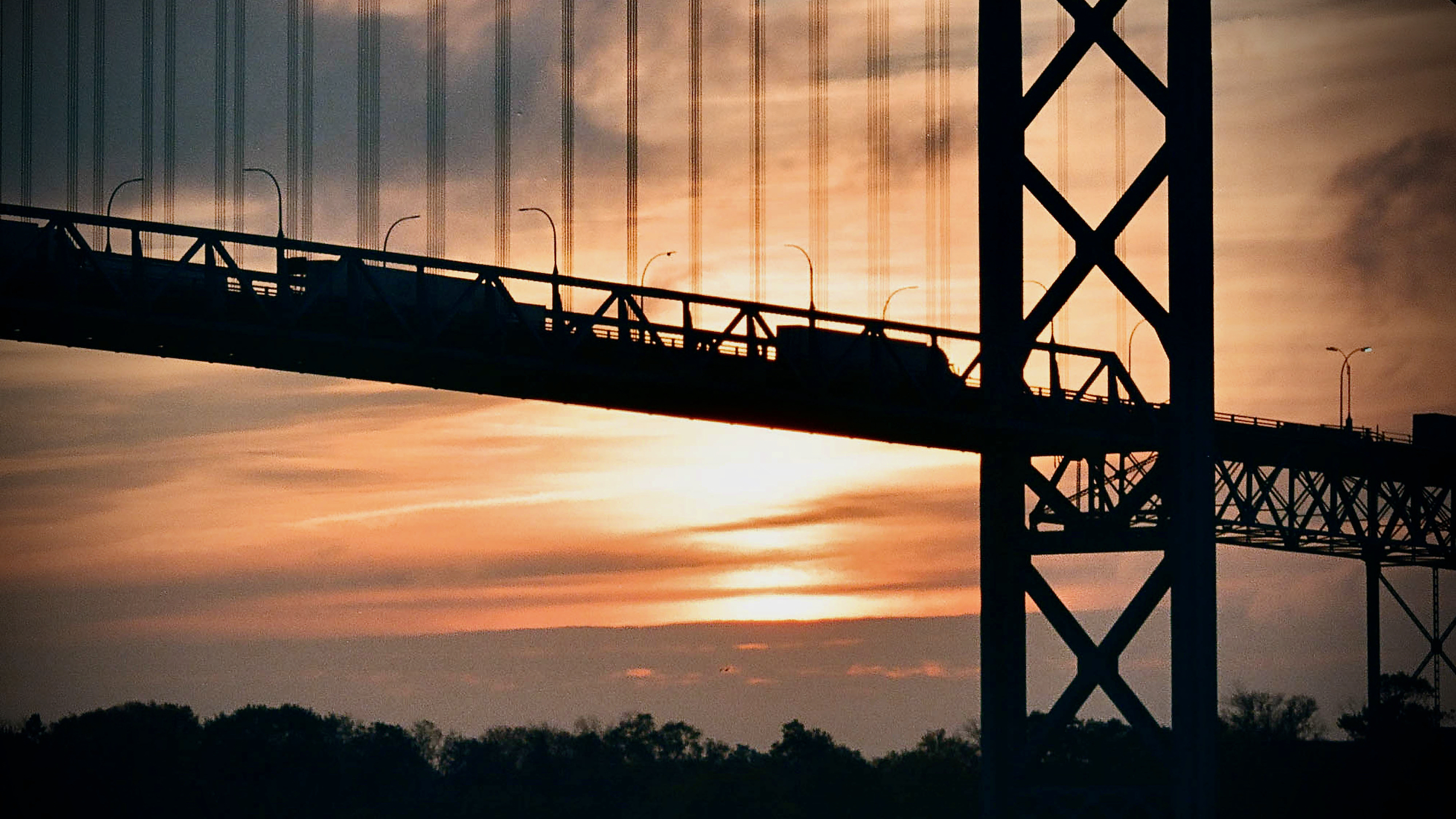 Trucks drive on the Ambassador Bridge, between Detroit and Windsor, at the U.S.-Canada border, which closed on Sept. 11, 2001.