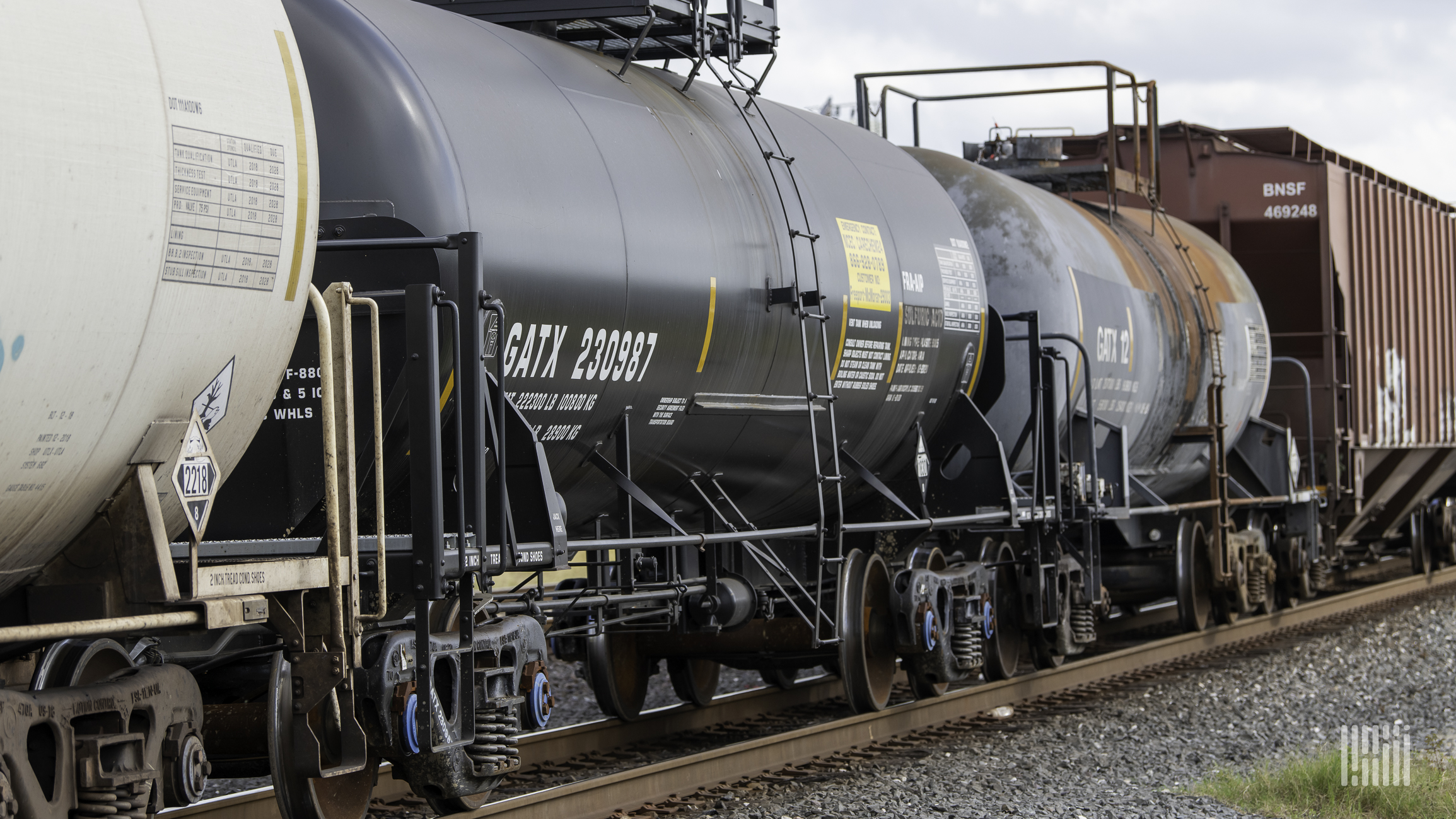 A photograph of a train hauling a variety of railcars.