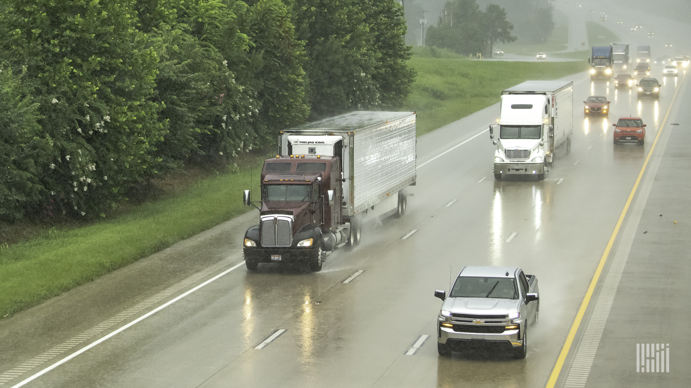 Tractor-trailers in heavy rain.