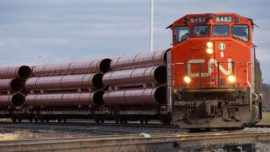A photograph of a CN train hauling metals equipment.