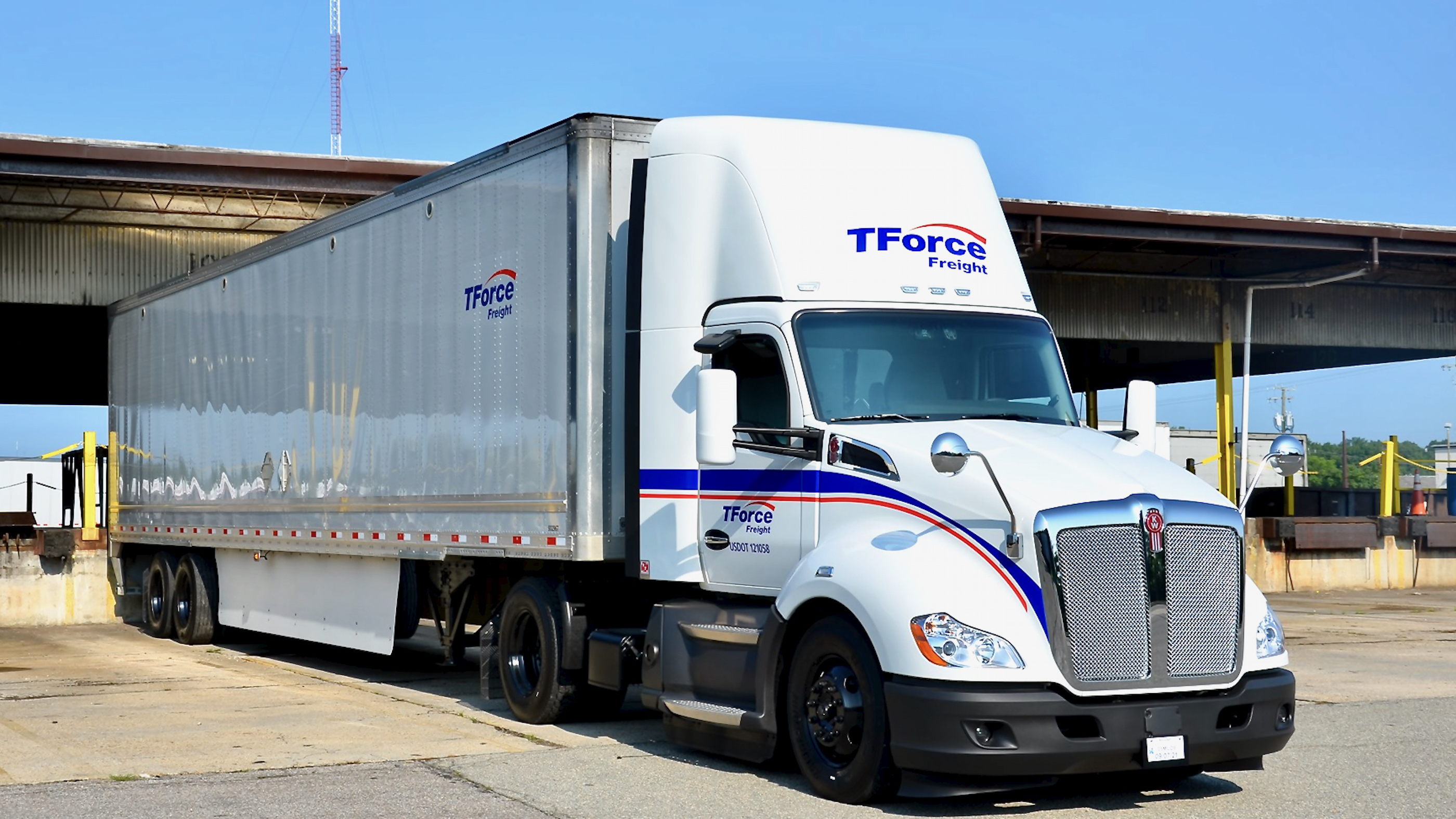 A tractor-trailer of TFI International's TForce Freight, formerly UPS Freight, seen from the front left.