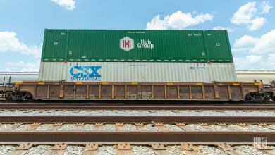 A photograph of a two intermodal containers stacked on top of a train.