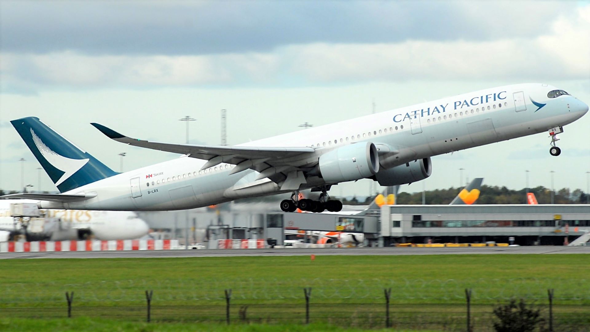 A Cathay Pacific A350 passenger jet takes off.