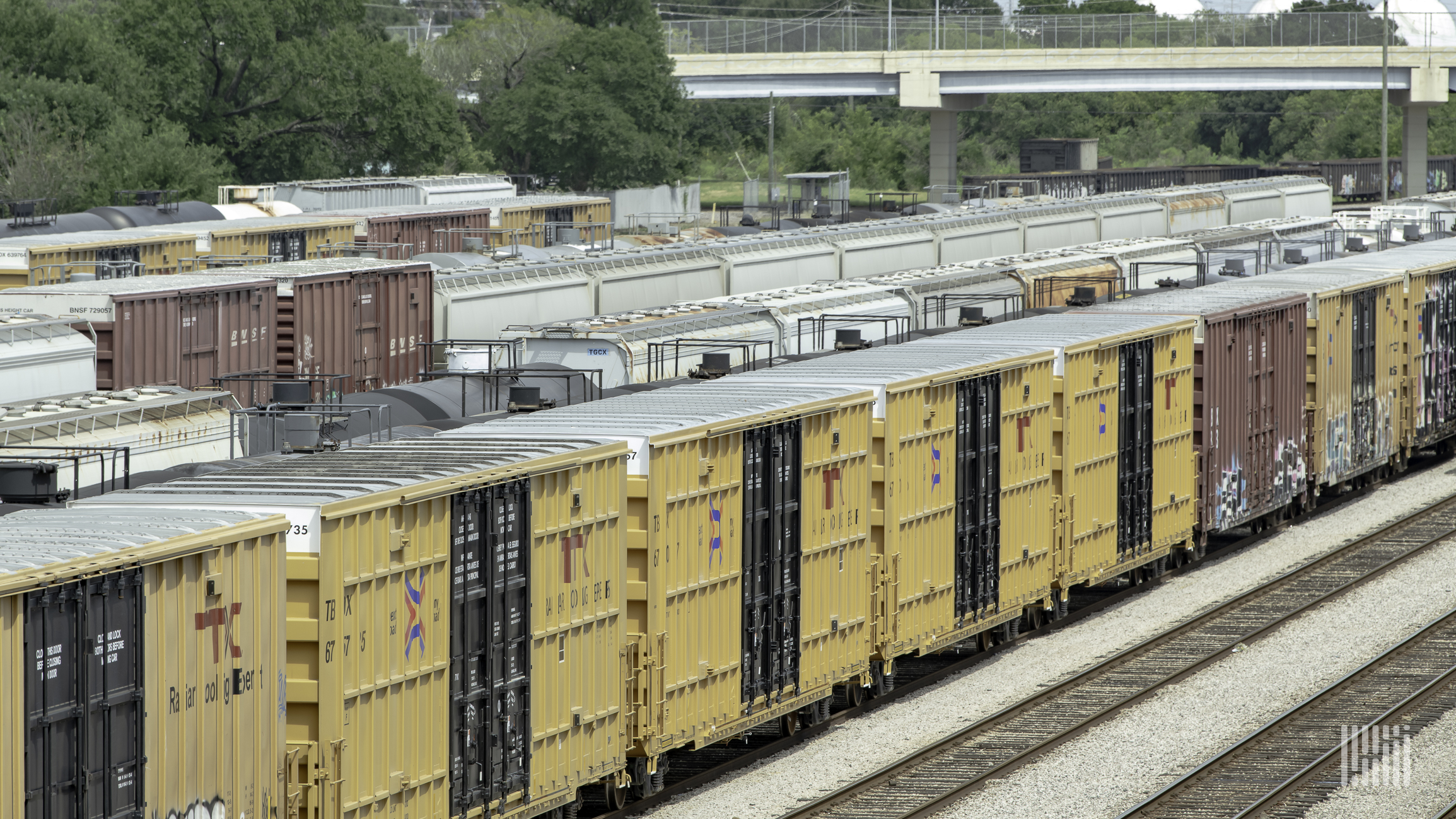 A photograph of a rail cars parked in a rail yard.