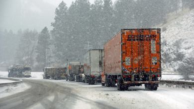 Tractor-trailers on a snowy road.