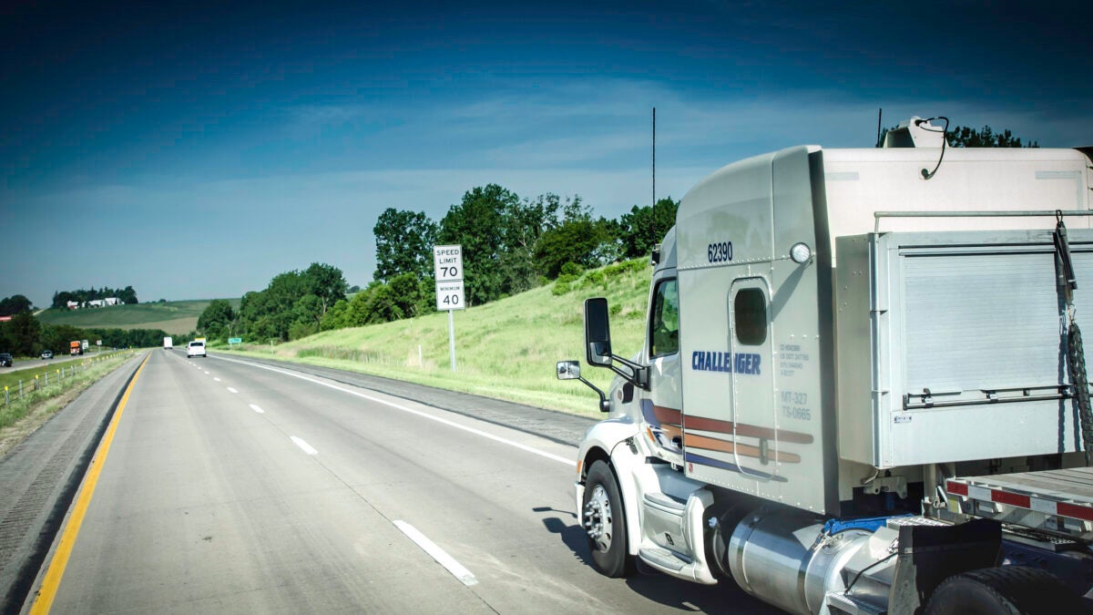 A view from the side as a tractor-trailer of Canadian trucking company Challenger.