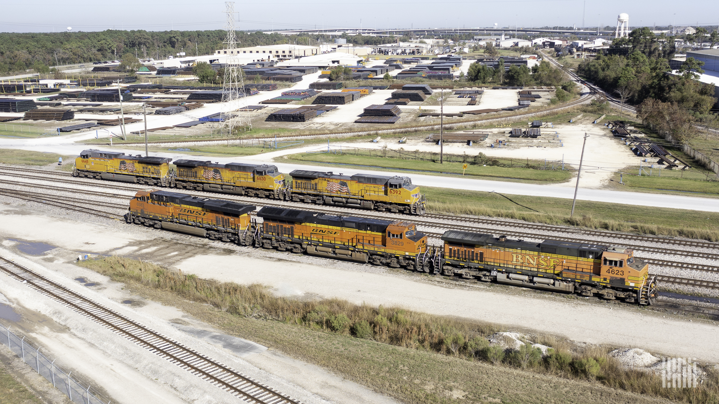 A photograph of a Union Pacific train and a BNSF train in a rail yarrd.