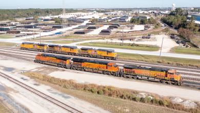 A photograph of a Union Pacific train and a BNSF train in a rail yarrd.