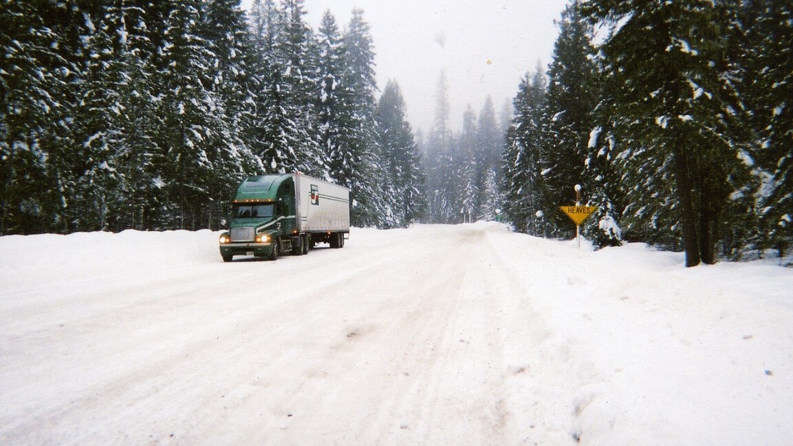 Tractor-trailer on snowy Idaho highway.