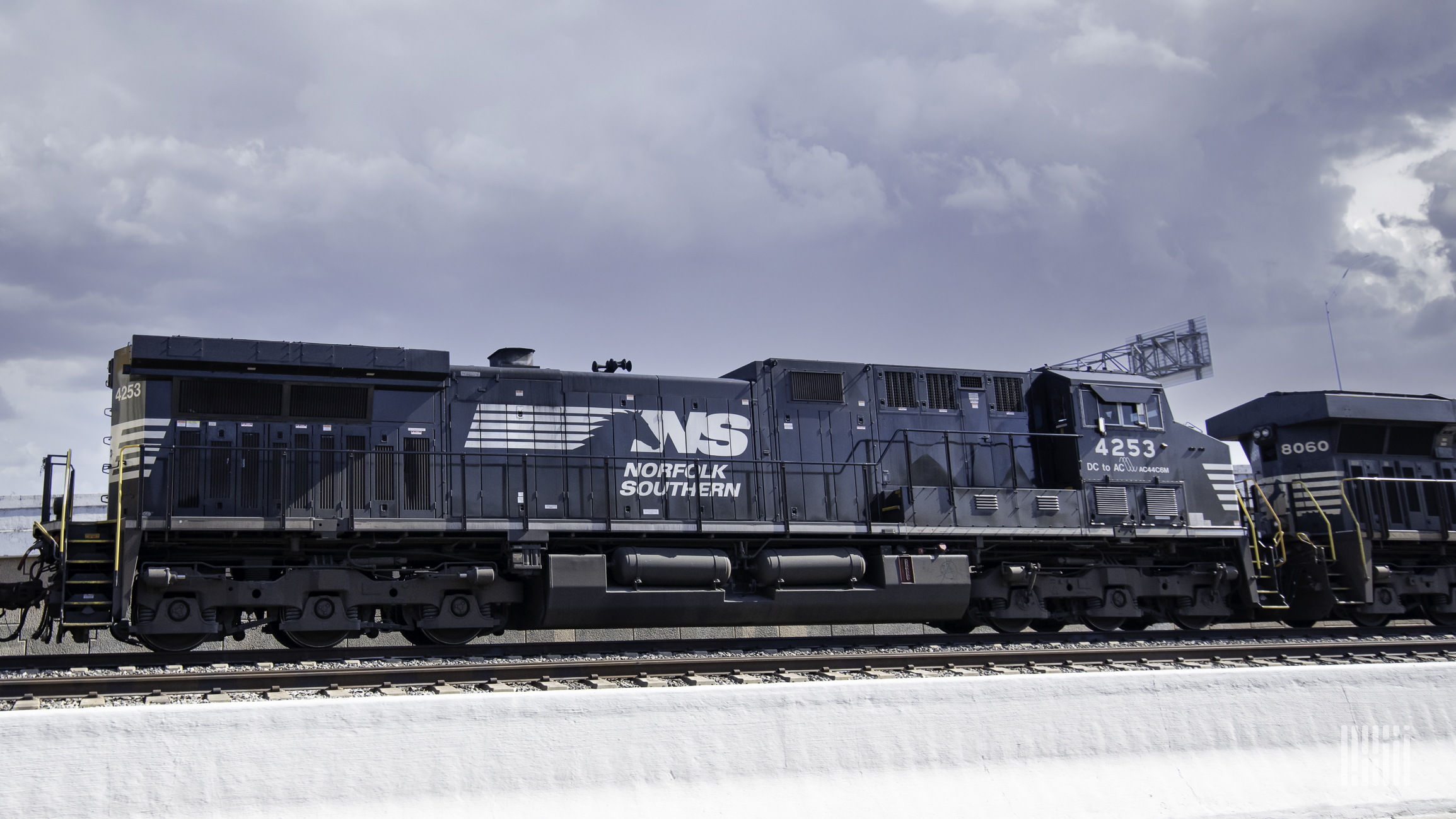 A photograph of a Norfolk Southern locomotive rolling down a train track.