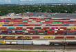 A photograph of intermodal containers parked in a rail yard.