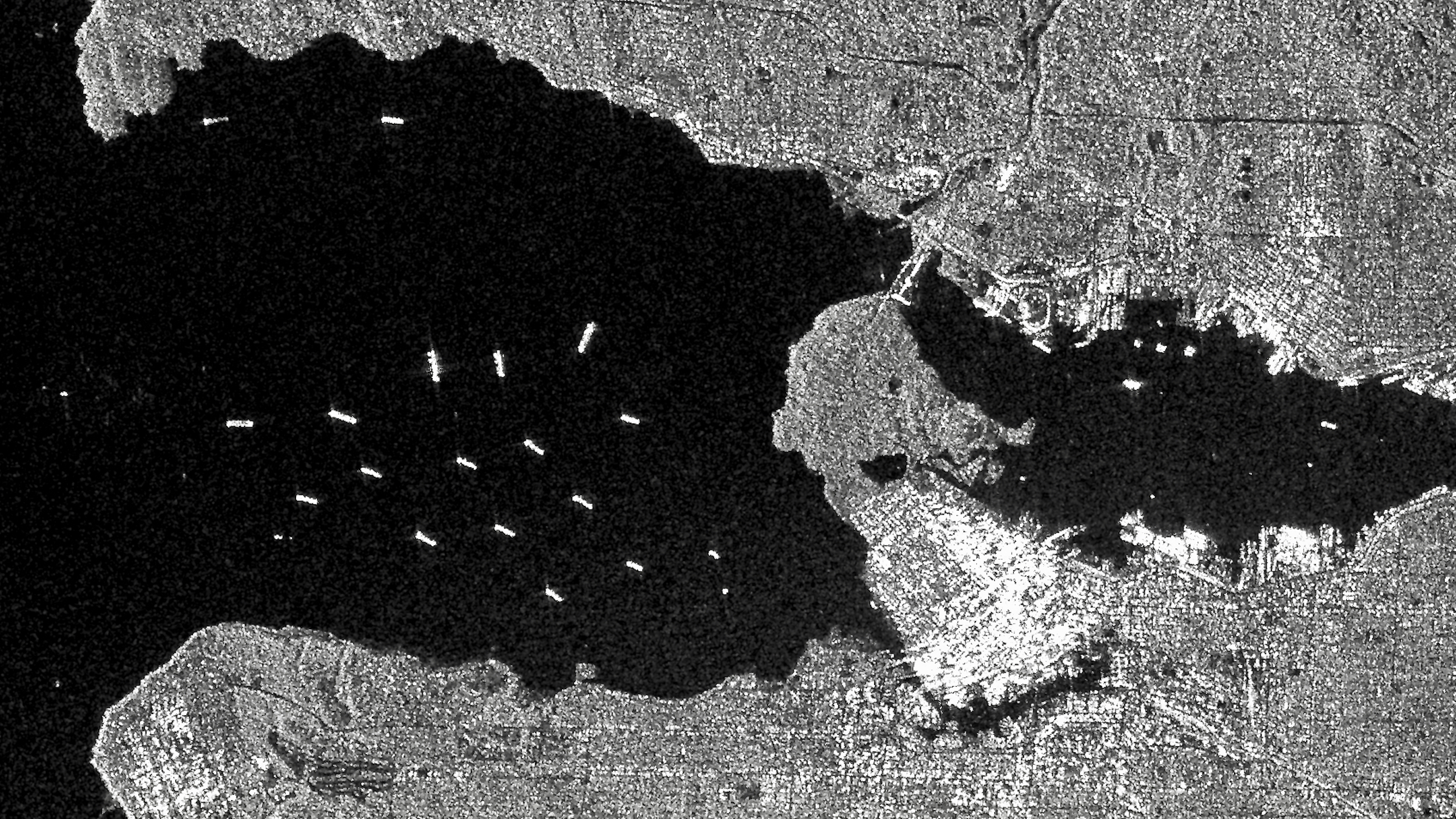 A black-and-white satellite radar image shows some of ships waiting at anchorages near the Port of Vancouver.