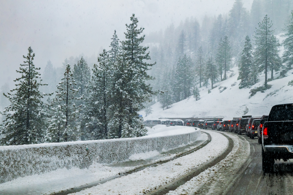 Cars and trucks stopped on a snow Sierra Nevada highway.