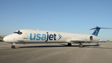 A white USA Jet cargo jet with twin-engines on the tail.
